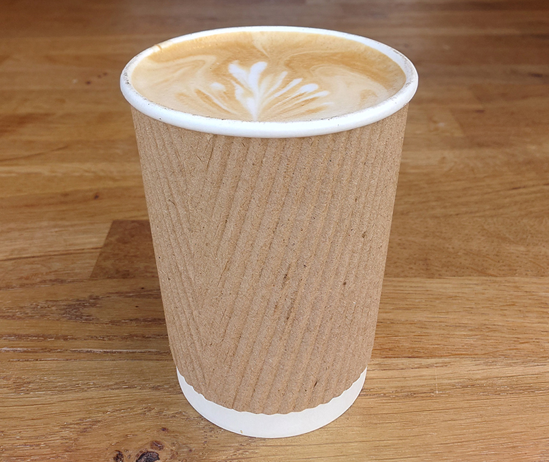 Freshly made flat white coffee in a takeaway cup at Gosport waterfront